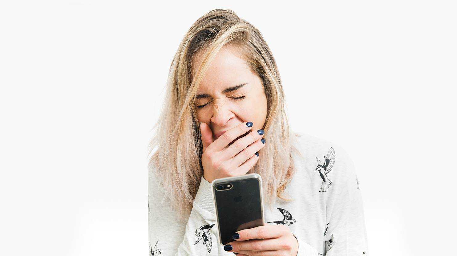 yawning woman with a smartphone